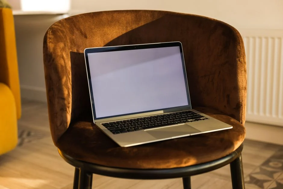 Dual monitors on a desk, showcasing web design in a modern office setting.